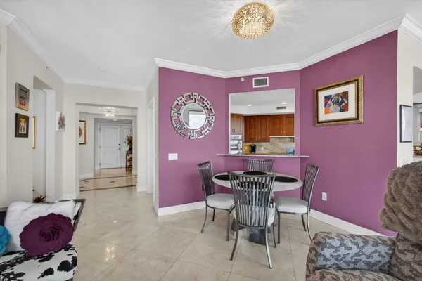 a dining room with furniture a chandelier and a rug