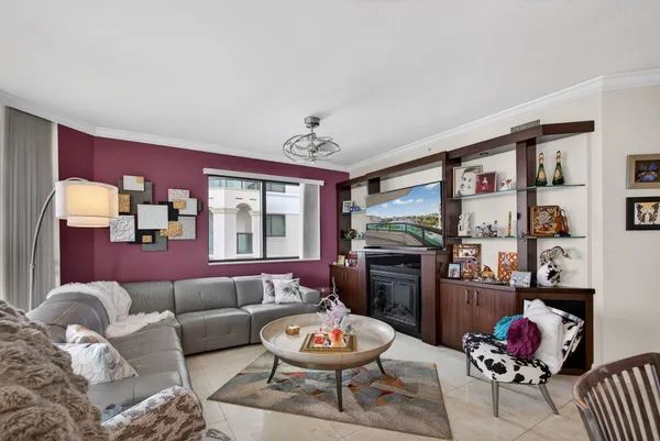 a dining room with stainless steel appliances kitchen island granite countertop a dining table chairs and a large window