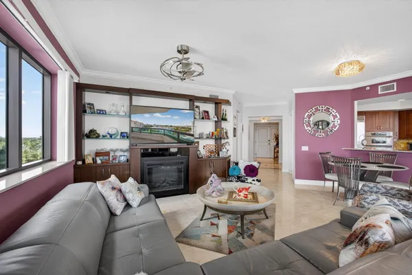 a kitchen with granite countertop wooden cabinets stainless steel appliances and a window