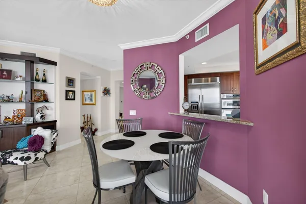 a large kitchen with granite countertop a large counter top space appliances and cabinets