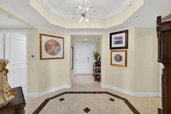 a living room with fireplace furniture and a view of kitchen