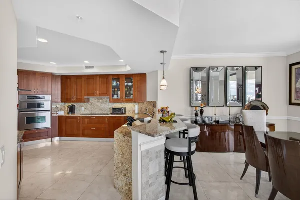 a bathroom with a sink a toilet a mirror a vanity and bathtub