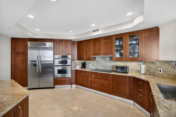 a kitchen with sink refrigerator and stove