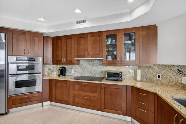 a bathroom with a double vanity sink toilet and shower