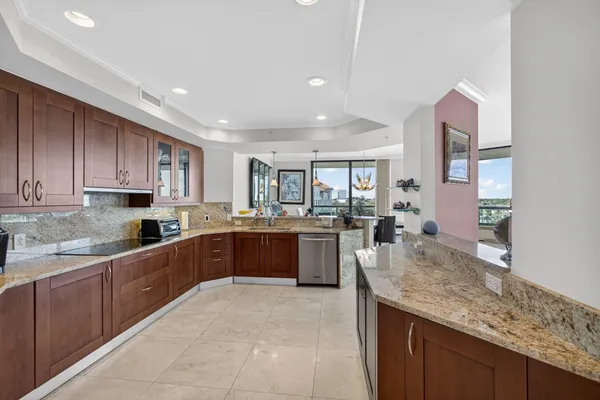 a spacious bathroom with a granite countertop sink a toilet and a mirror