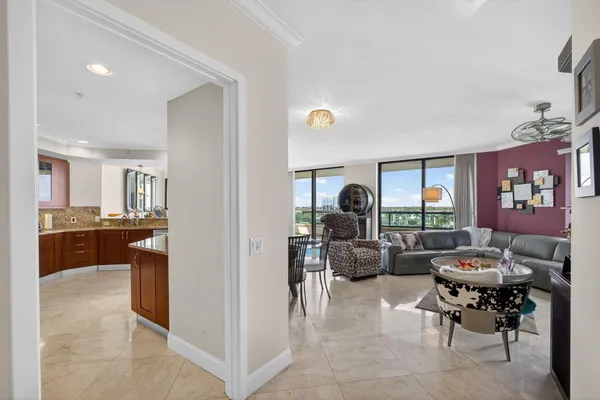 a living room with furniture fireplace and a large window