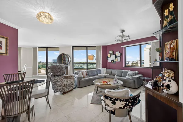 a living room with furniture and a wall painting