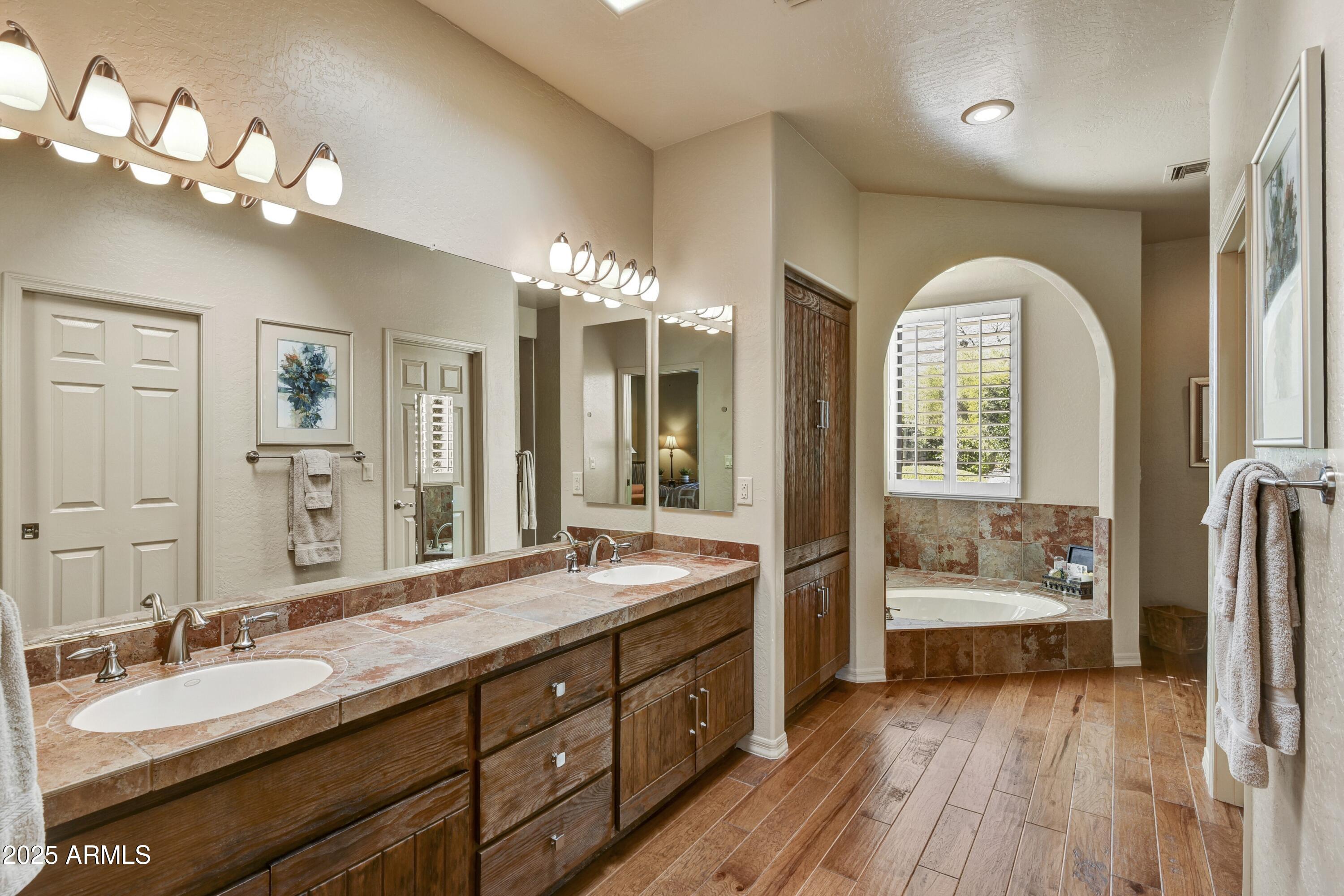 25004 North Vado Court Rio Verde, AZ 85263 - Photo 12 of 18 a spacious bathroom with a double vanity sink and a mirror
