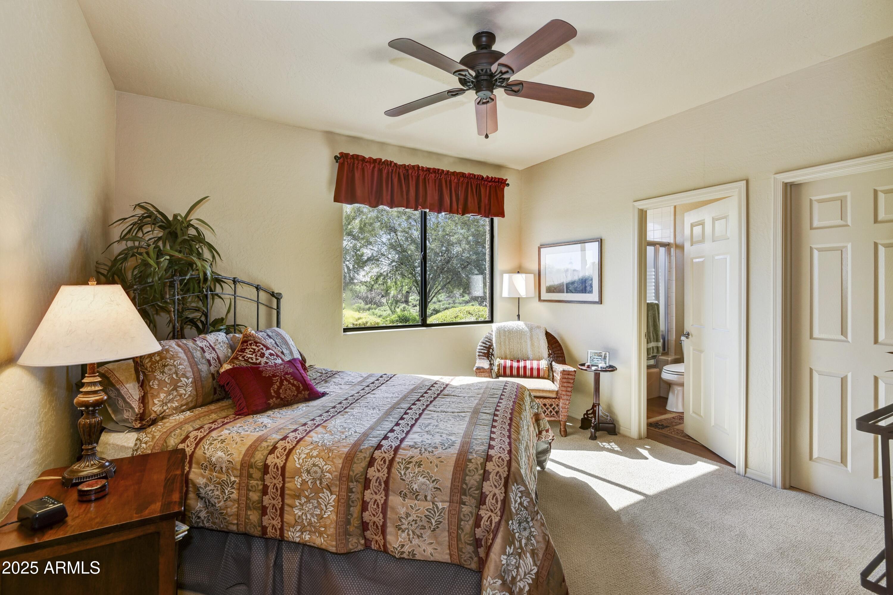 25004 North Vado Court Rio Verde, AZ 85263 - Photo 13 of 18 a bedroom with a bed and a chandelier