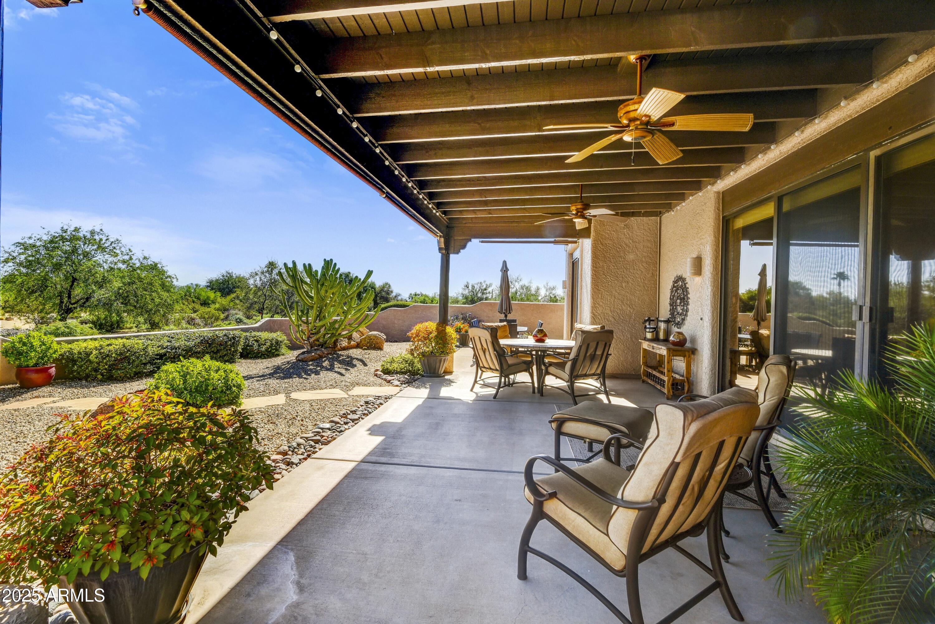 25004 North Vado Court Rio Verde, AZ 85263 - Photo 15 of 18 a view of a patio with table and chairs potted plants with floor to ceiling window and potted plants