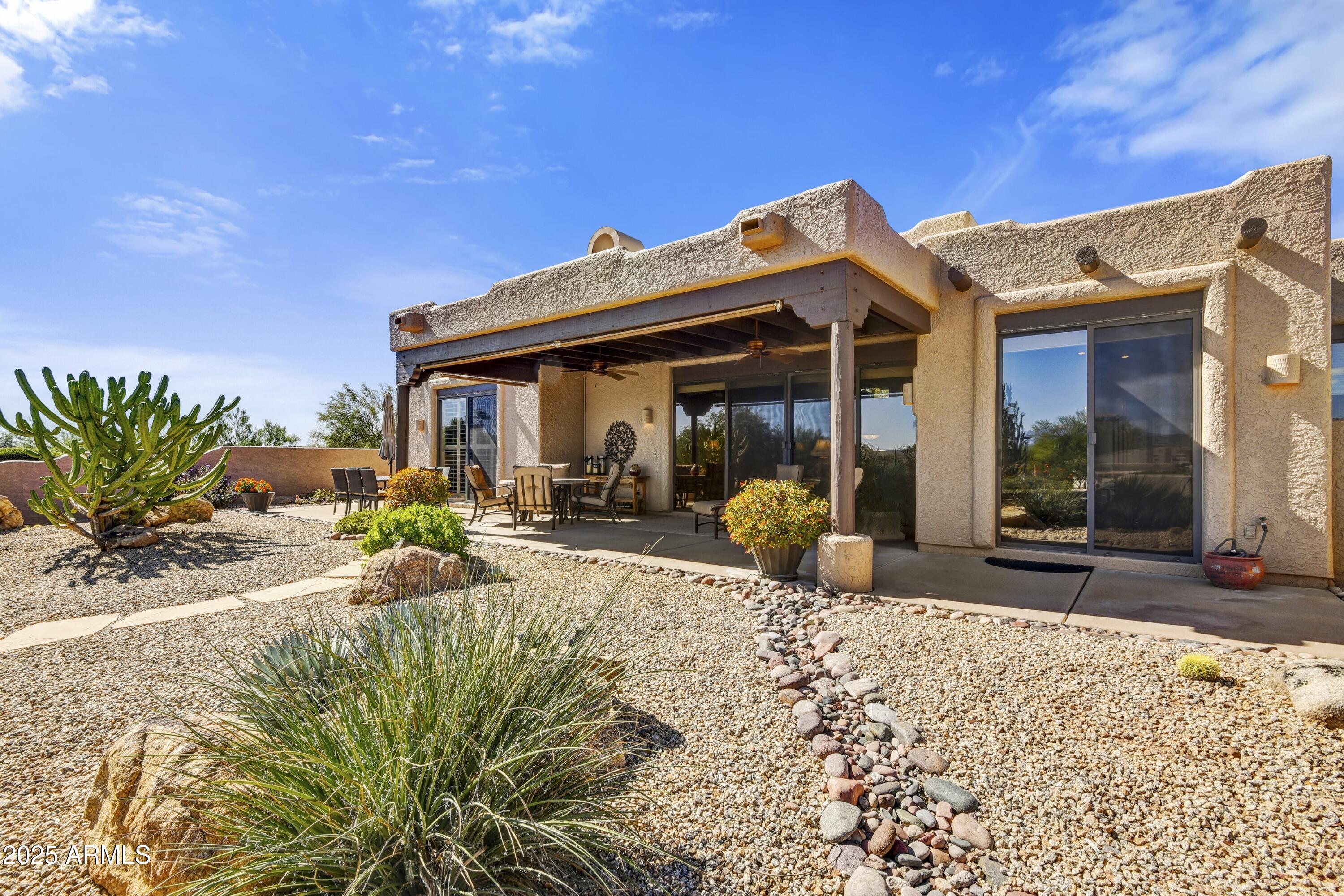 25004 North Vado Court Rio Verde, AZ 85263 - Photo 16 of 18 a view of a house with backyard and porch