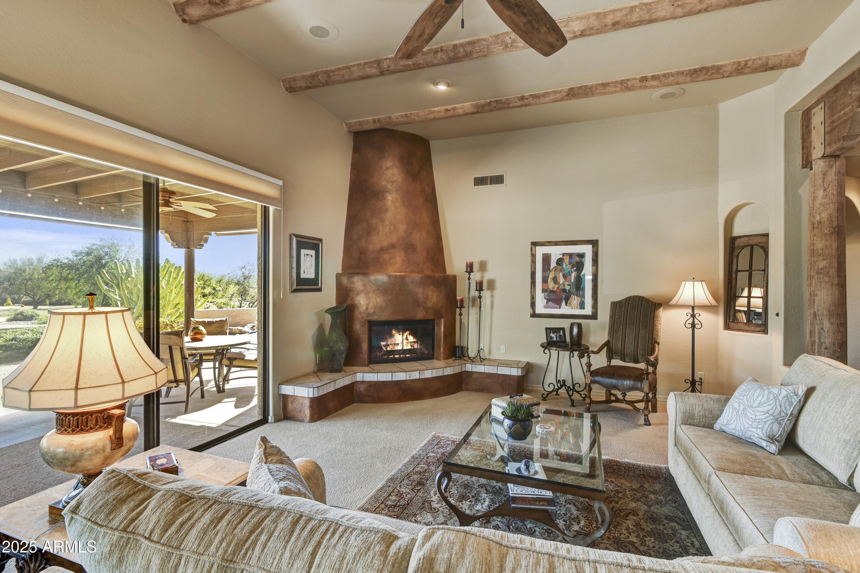 25004 North Vado Court Rio Verde, AZ 85263 - Photo 3 of 18 a living room with furniture a large window and a fireplace