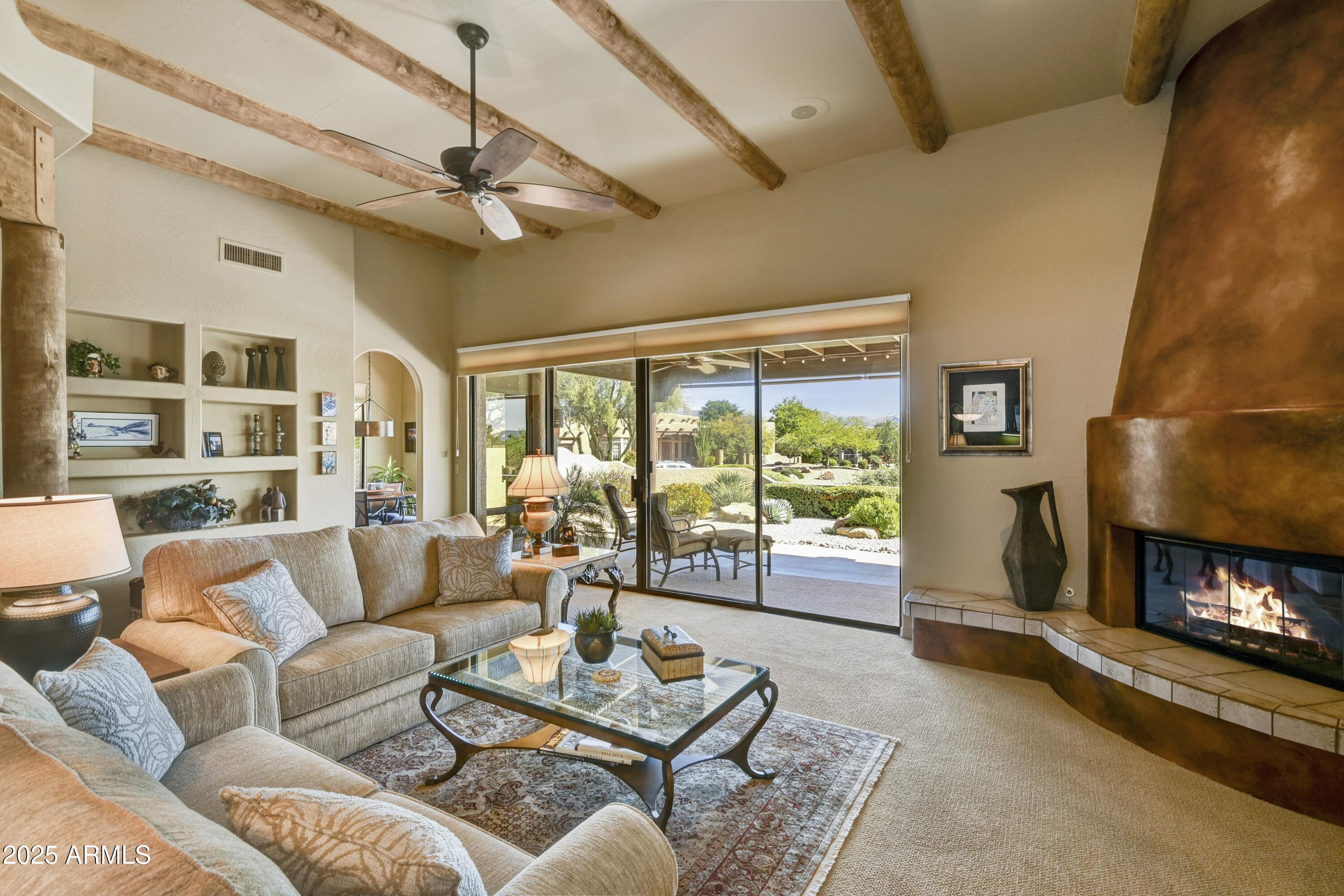 25004 North Vado Court Rio Verde, AZ 85263 - Photo 4 of 18 a living room with furniture and a fireplace