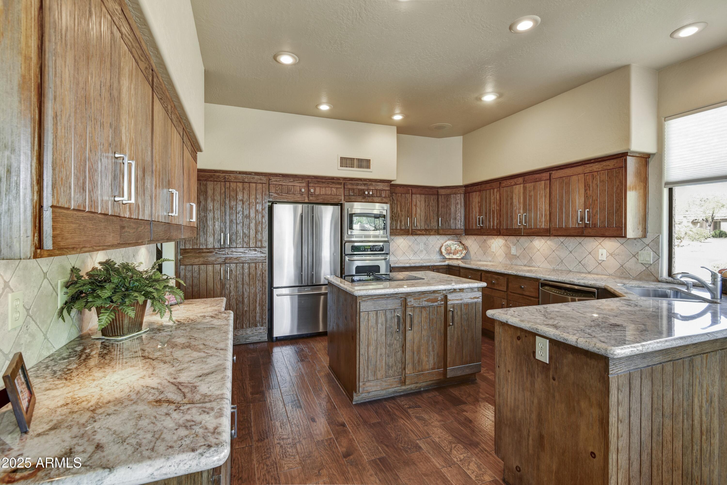 25004 North Vado Court Rio Verde, AZ 85263 - Photo 7 of 18 a kitchen with a sink stove and refrigerator