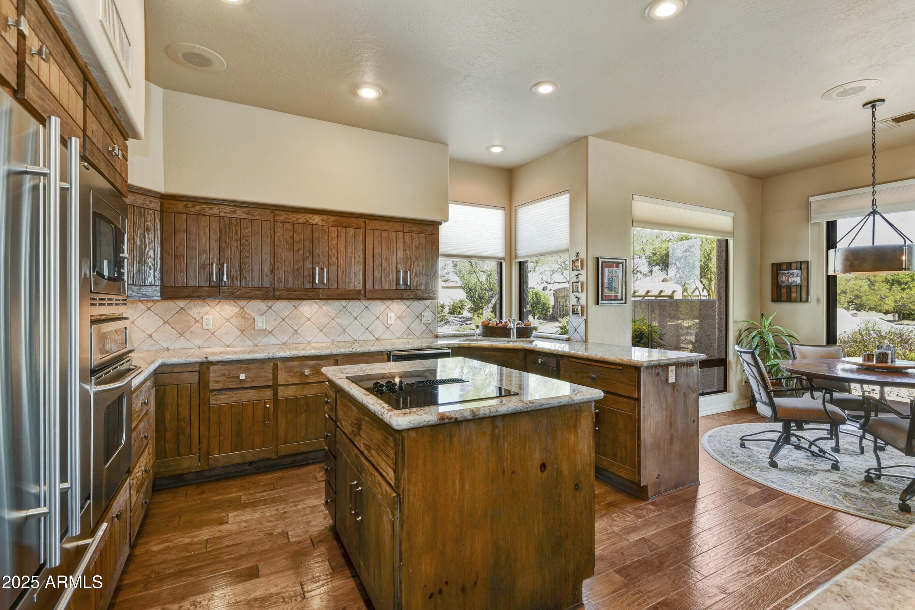 25004 North Vado Court Rio Verde, AZ 85263 - Photo 8 of 18 a kitchen with stainless steel appliances granite countertop a sink stove and refrigerator