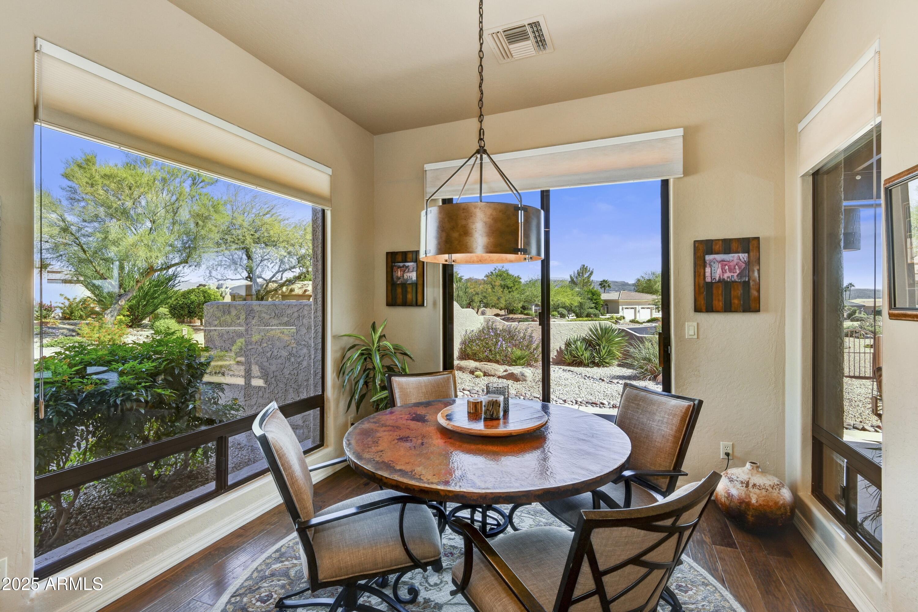 25004 North Vado Court Rio Verde, AZ 85263 - Photo 9 of 18 a view of a dining room with furniture window and wooden floor