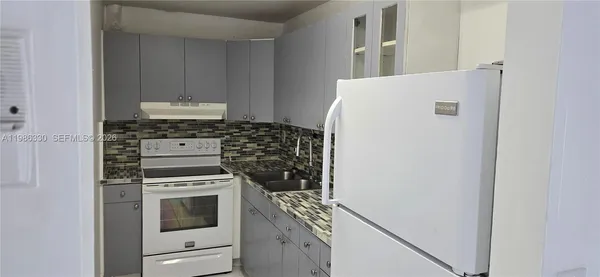 a kitchen with a stove and a refrigerator