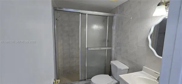 a white toilet sitting next to a bathroom sink