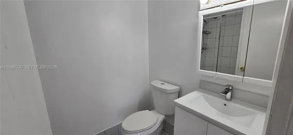 a bathroom with a sink a toilet and vanity