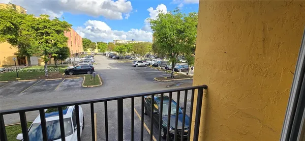 a view of a balcony with chairs and potted plants