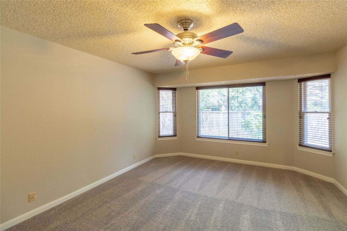 5839 Secrest Drive Austin, TX 78759 - Photo 14 of 34 Carpeted empty room with a textured ceiling and a ceiling fan