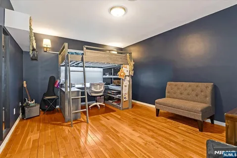 a living room with furniture a flat screen tv and a table