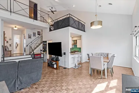 a view of a livingroom with furniture wooden floor and a chandelier