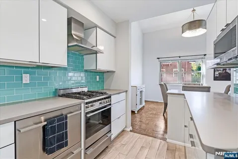 a kitchen with a stove a sink and a microwave