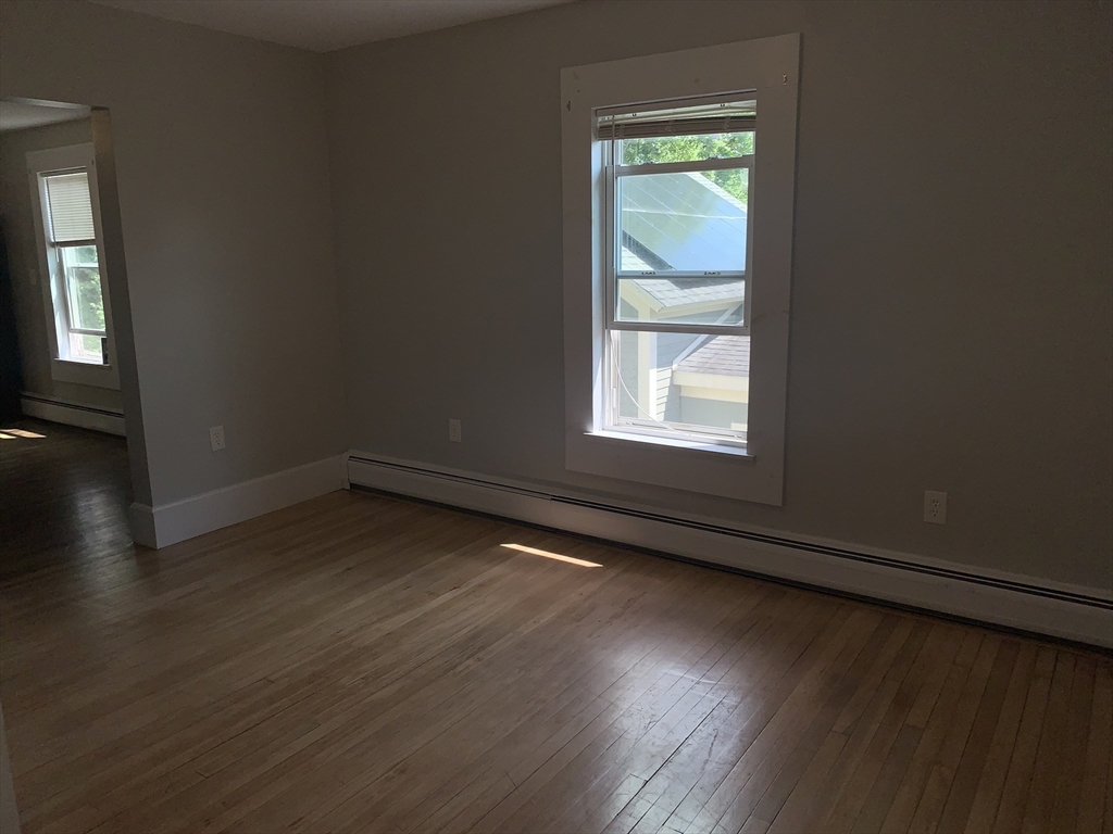 230 Prospect Street Athol, MA 01331 - Photo 13 of 19 an empty room with wooden floor and windows