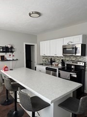 230 Prospect Street Athol, MA 01331 - Photo 8 of 19 a kitchen with stainless steel appliances a stove a sink a microwave and cabinets