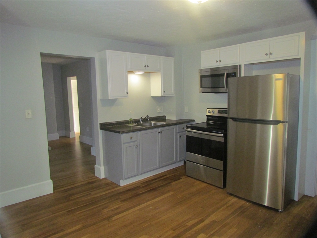 230 Prospect Street Athol, MA 01331 - Photo 10 of 19 a kitchen with a refrigerator and a stove top oven