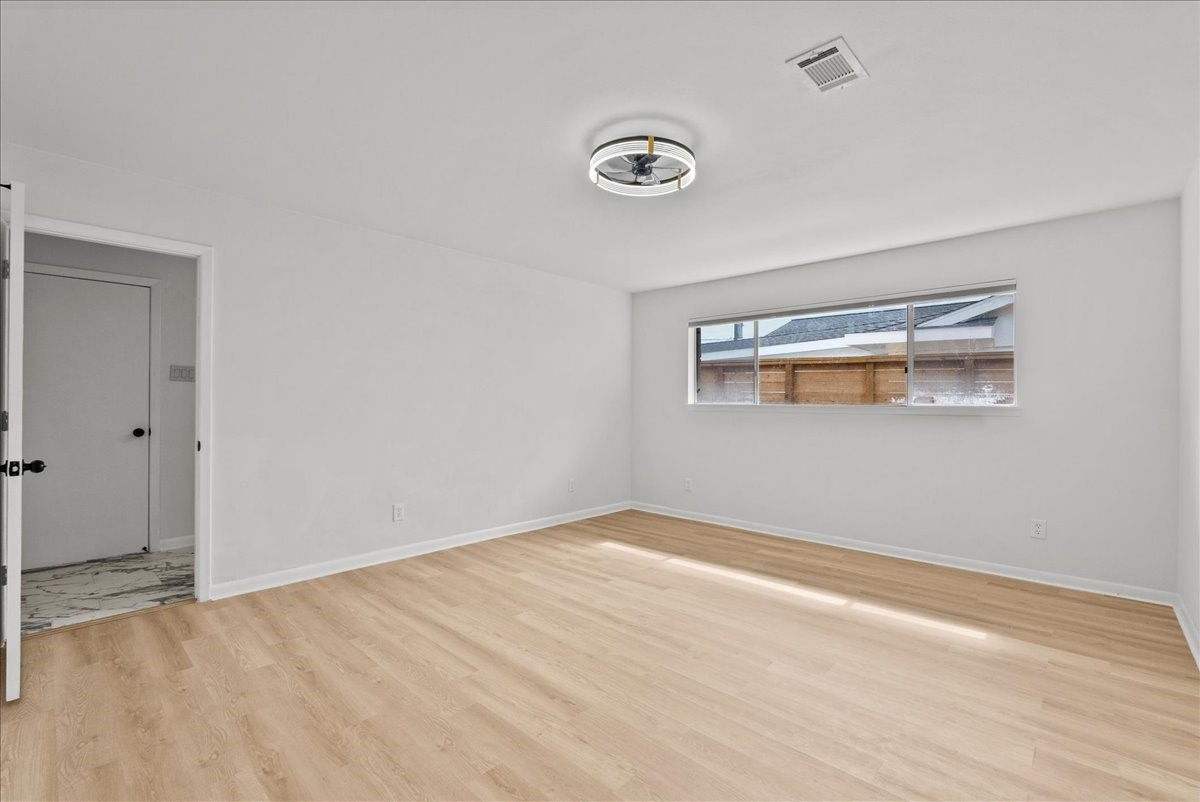 5762 Birdwood Road Houston, TX 77096 - Photo 24 of 50 ENTER INTO YOUR VAST PRIMARY SUITE. HAVE YOU NOTICED THE SAME FLOORING THROUGHOUT THE HOME?