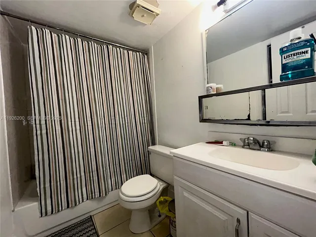 a bathroom with a sink toilet and mirror