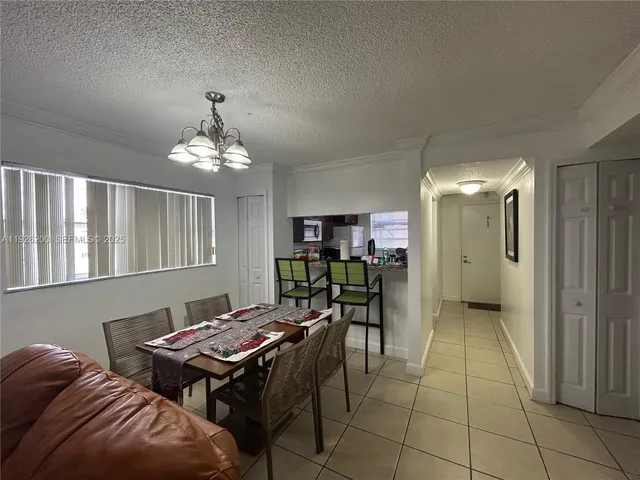 a view of a livingroom with furniture and chandelier