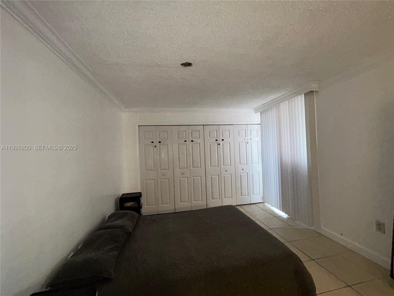 19805 Southwest 114th Avenue, Unit 219 Miami, FL 33157 - Photo 6 of 12 a bedroom with a bed and a window