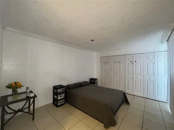 a bedroom with a bed and a chair
