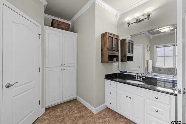 a bathroom with a granite countertop sink mirror and