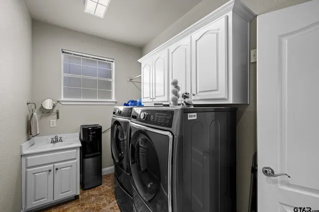 a utility room with sink dryer and washer