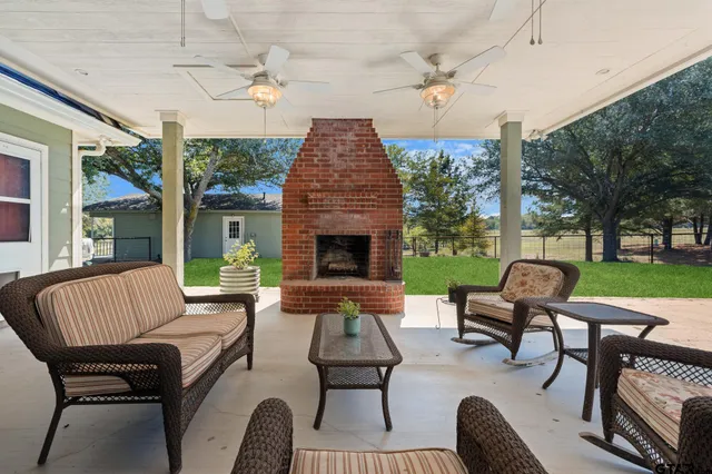 a outdoor living space with patio furniture and a fireplace