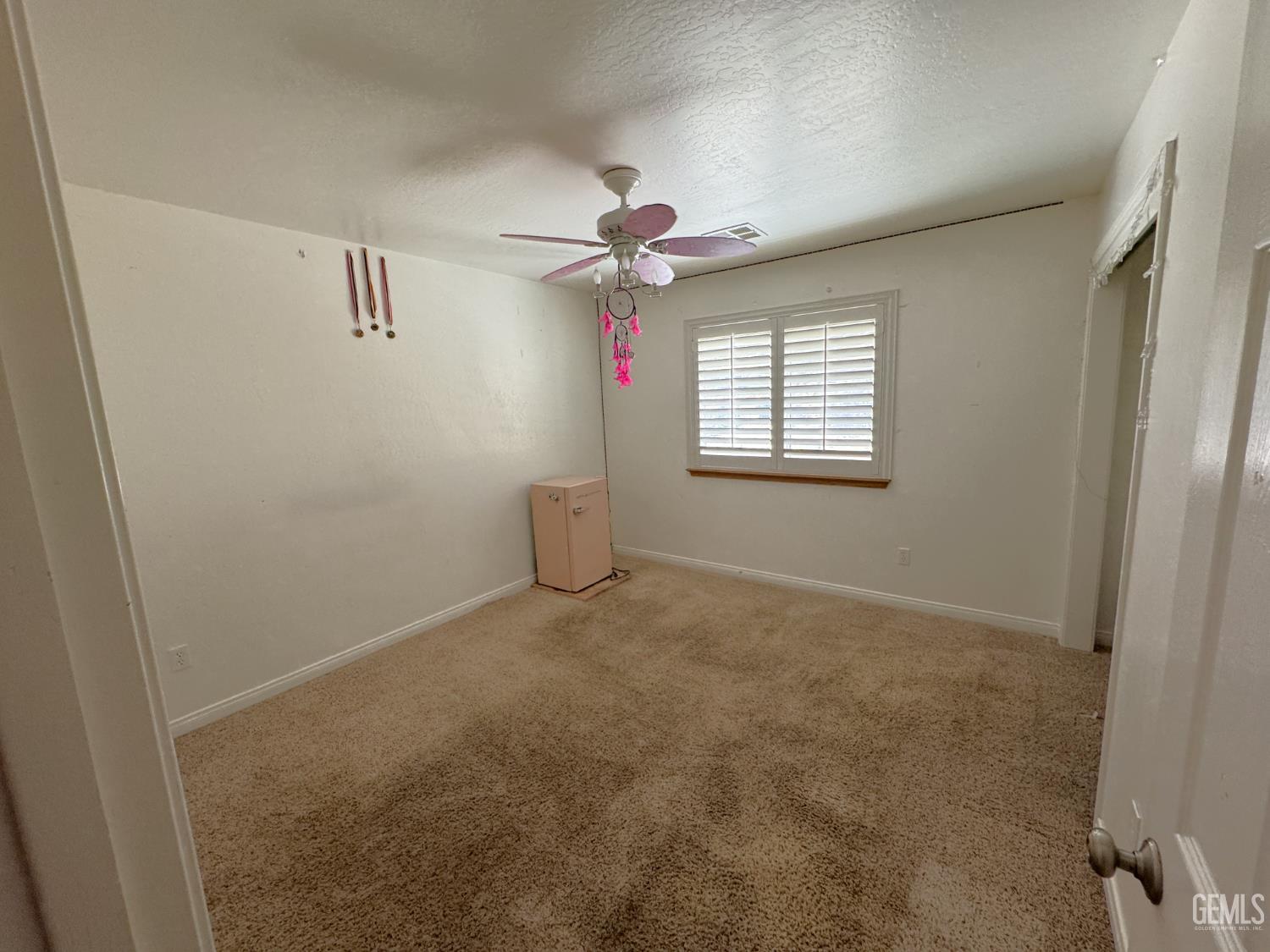 Undisclosed Address Tehachapi, CA 93561 - Photo 10 of 16 an empty room with windows and fan