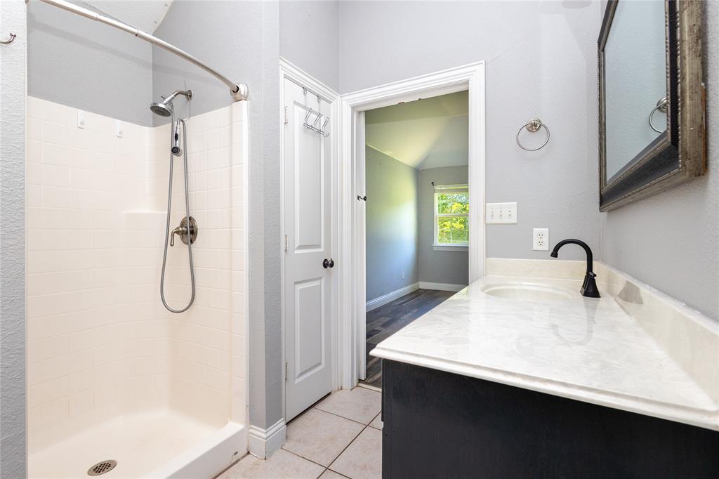 512 Milton Road Josephine, TX 75173 - Photo 11 of 31 a bathroom with a granite countertop sink and a mirror