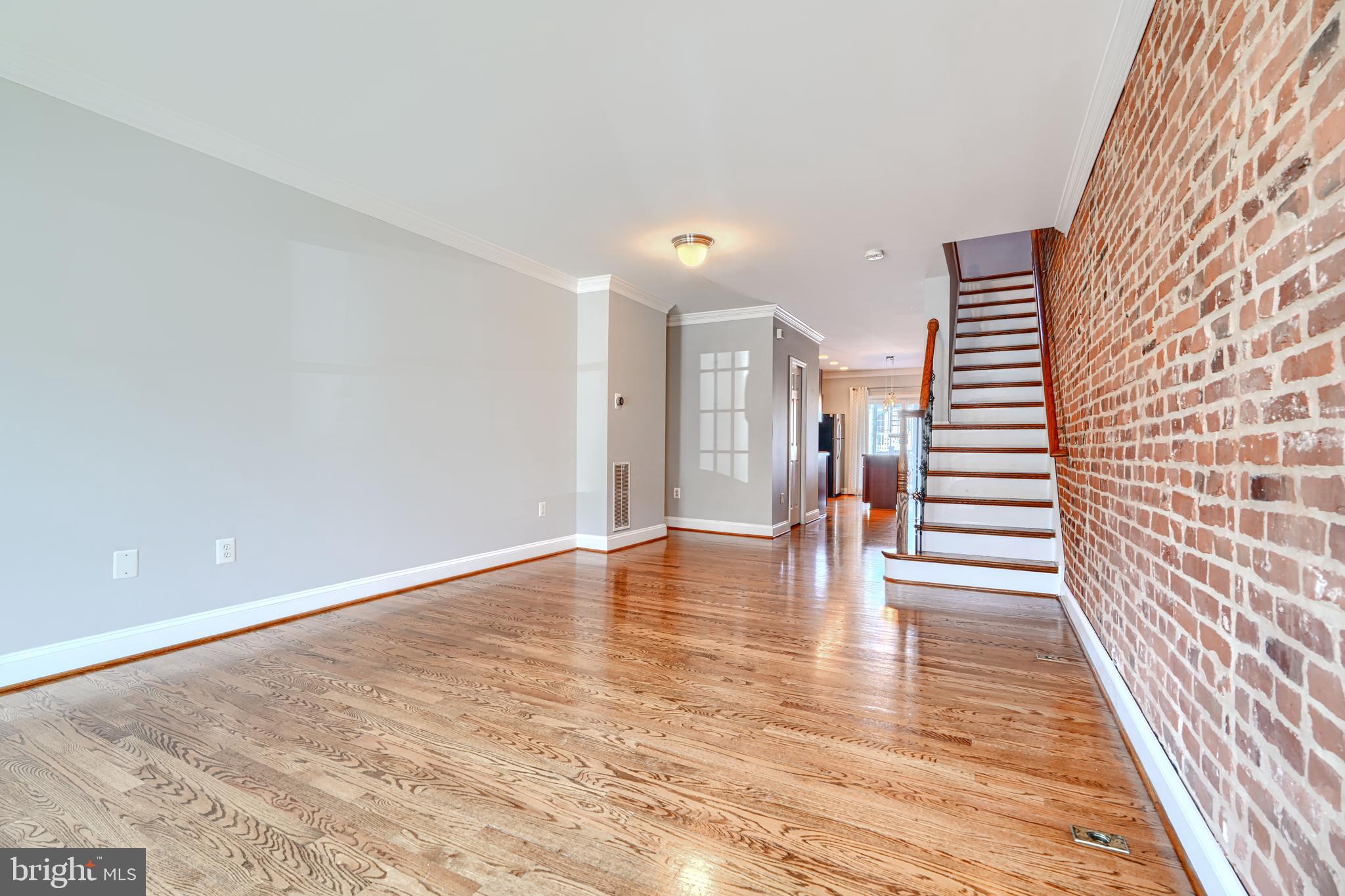 612 South Clinton Street Baltimore, MD 21224 - Photo 3 of 39 Exposed brick and hardwoods