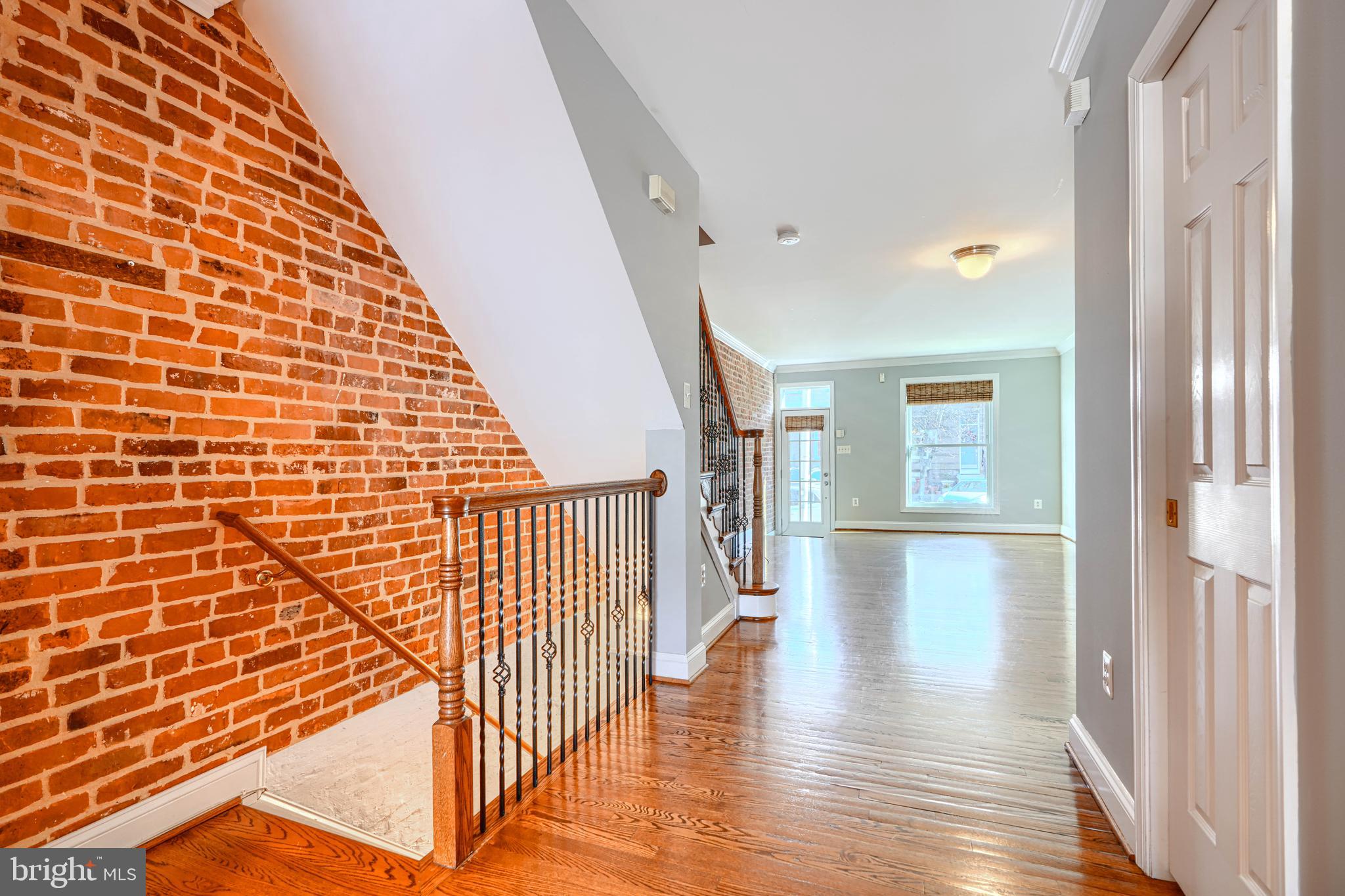 612 South Clinton Street Baltimore, MD 21224 - Photo 4 of 39 Exposed brick and hardwoods