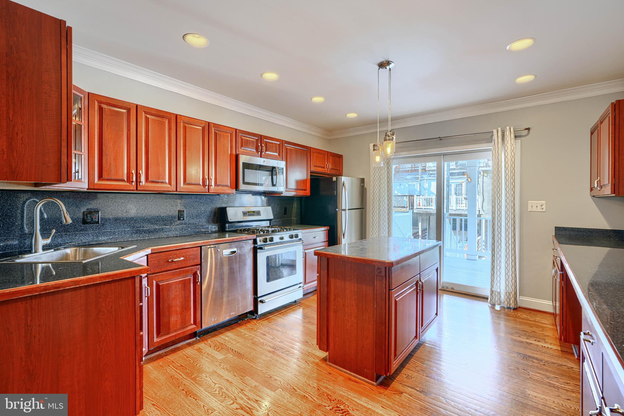 612 South Clinton Street Baltimore, MD 21224 - Photo 8 of 39 Kitchen has sliders to the back covered porch