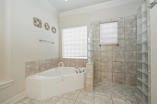 a white bath tub sitting in a bathroom next to a window