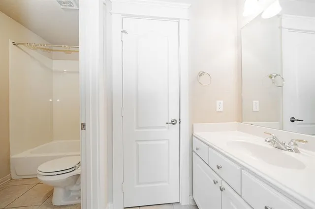 a bedroom with a bed and a desk