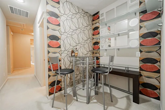 a living room with pool table and windows