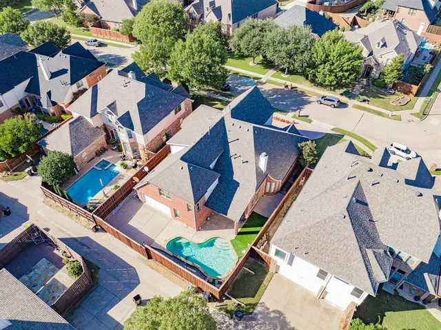 an aerial view of residential house with outdoor space and swimming pool