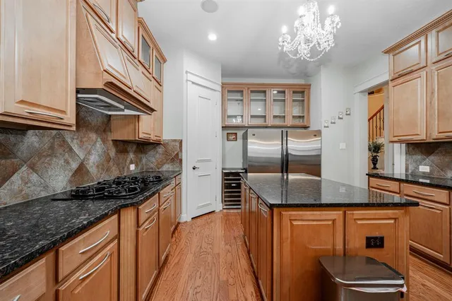 a kitchen with stainless steel appliances granite countertop a sink and cabinets