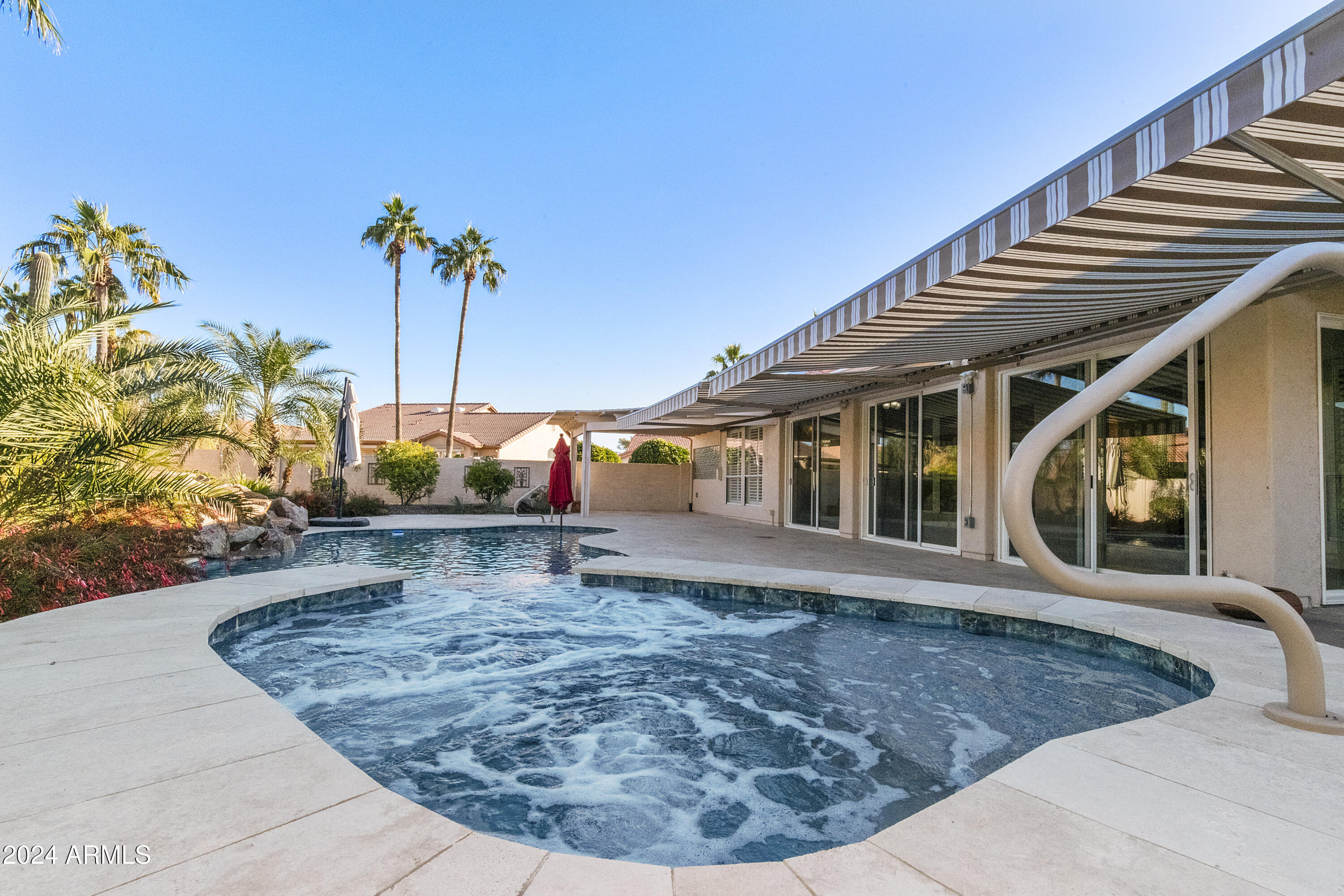 25418 East Spring Creek Road Chandler, AZ 85248 - Photo 50 of 52 Pool with waterfall from spa to pool